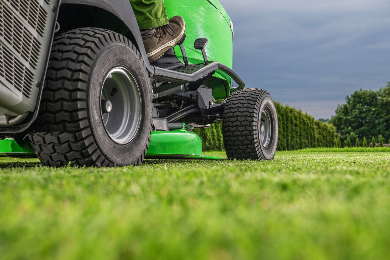 Gardening and Landscaping Theme. Outdoor Power Equipment Riding Lawn Mower Tractor Job. Grass Mowing Work.