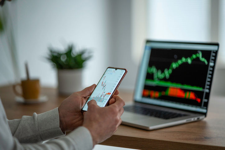 Mature man checking on trading positions and stock markets.