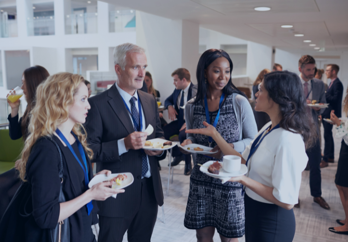 Group of people networking and chatting in an office setting