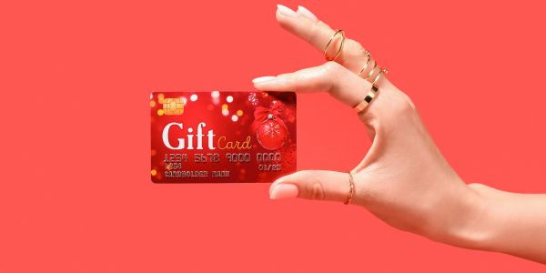 Hand holding up a red gift card