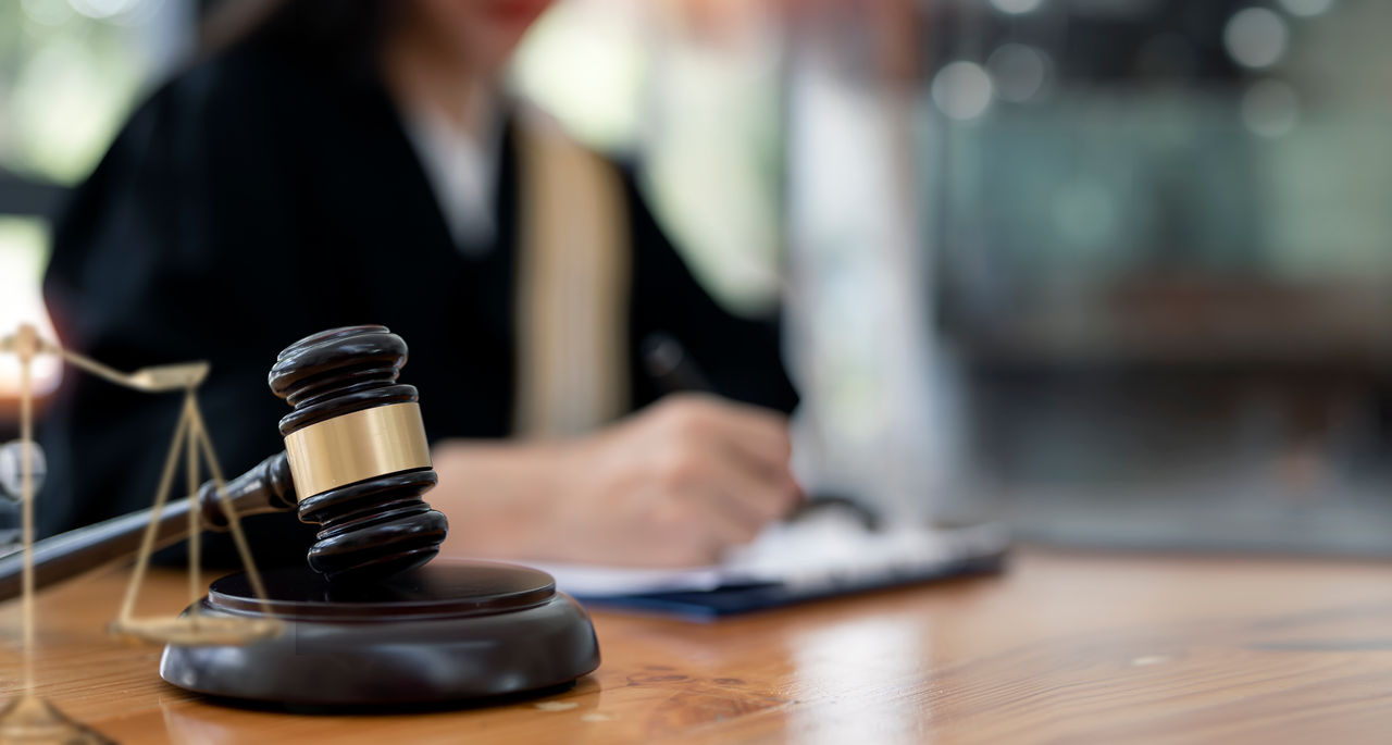 Wooden judge gavel on the table. Lawyer working in office. Law and justice concept.