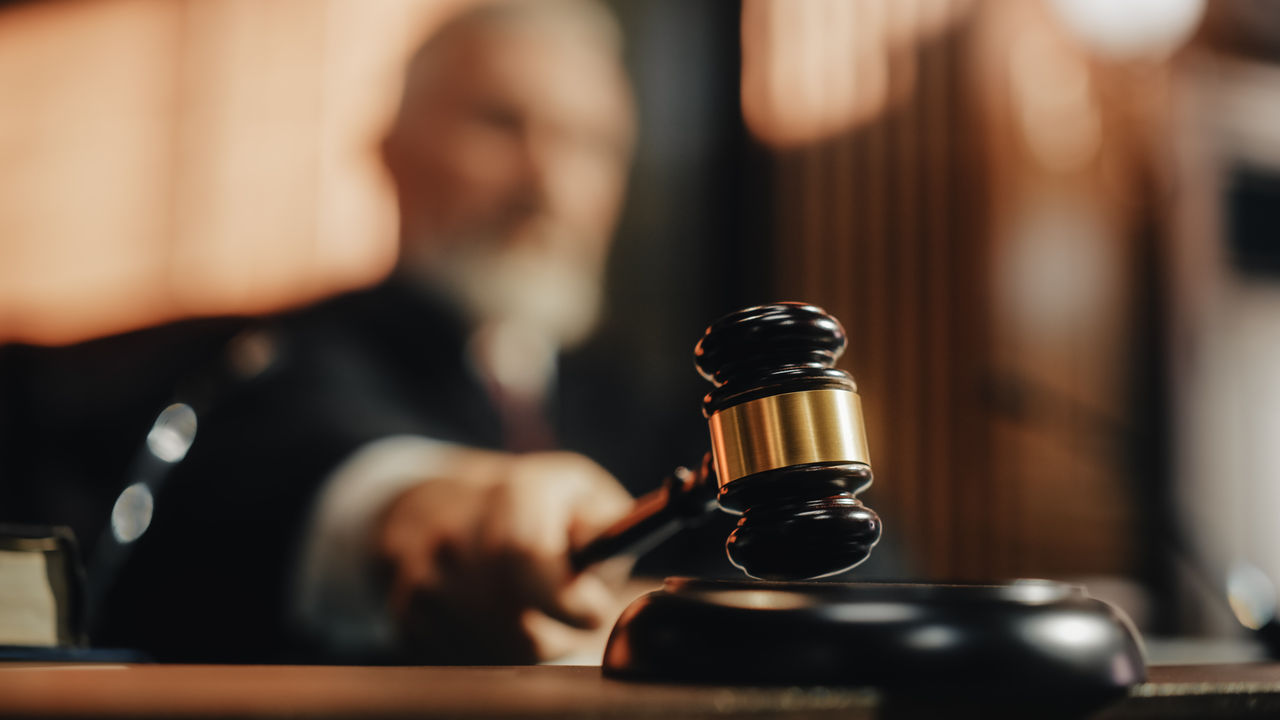 Court of Law and Justice Trial Session: Imparcial Honorable Judge Pronouncing Sentence, striking Gavel. Focus on Mallet, Hammer. Cinematic Shot of Dramatic Not Guilty Verdict. Close-up Shot.