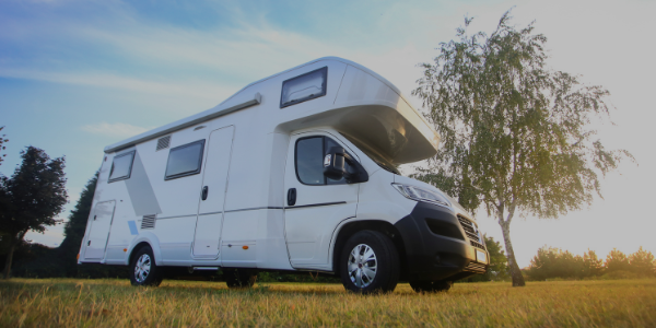 white camper sitting in field