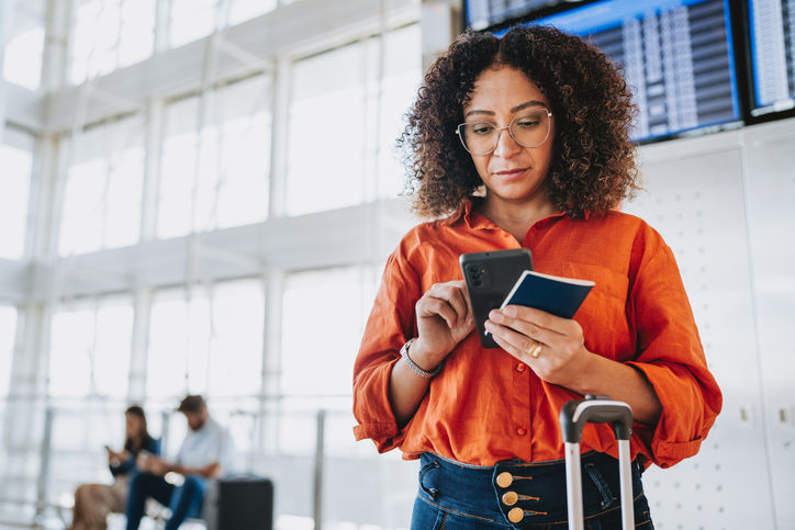 Portrait of a Woman at the airport checking flights on the dashboard