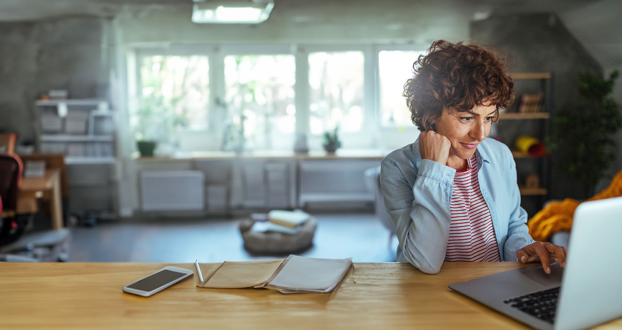 Photo of mature woman working at home