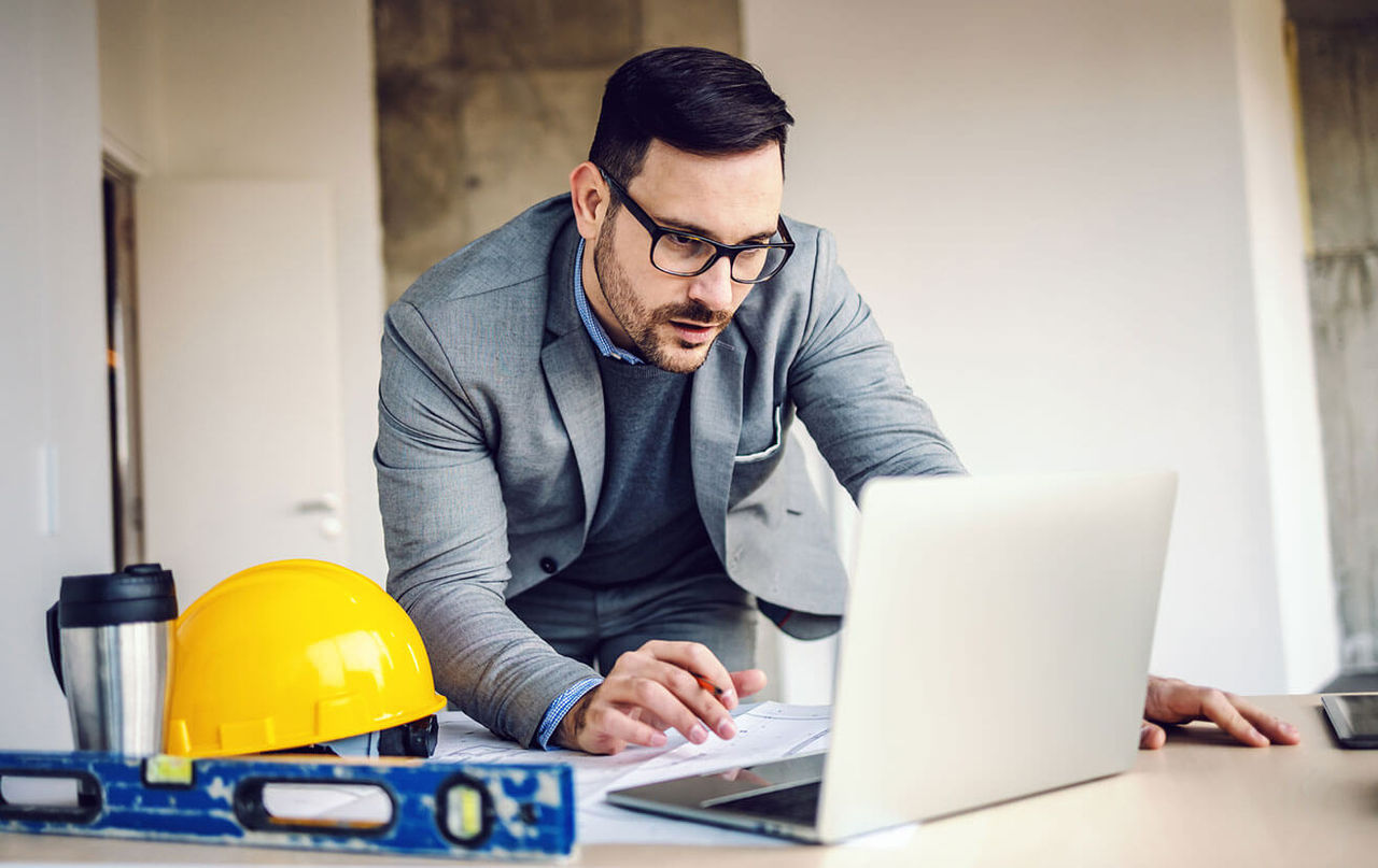 Contractor on his laptop on the job site