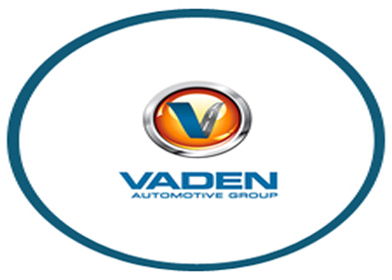 white background with blue circle with vaden automotive group written in blue above it a silver circle with orange inside and blue v on the orange