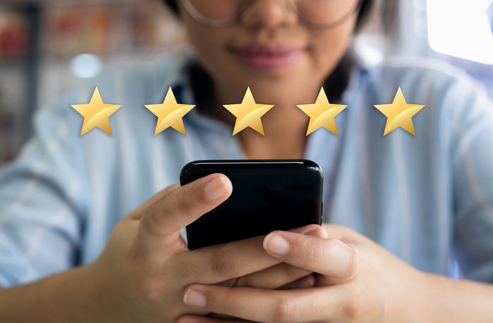 5 star customer experience satisfaction score with gold stars and satisfied customer filling in business survey
