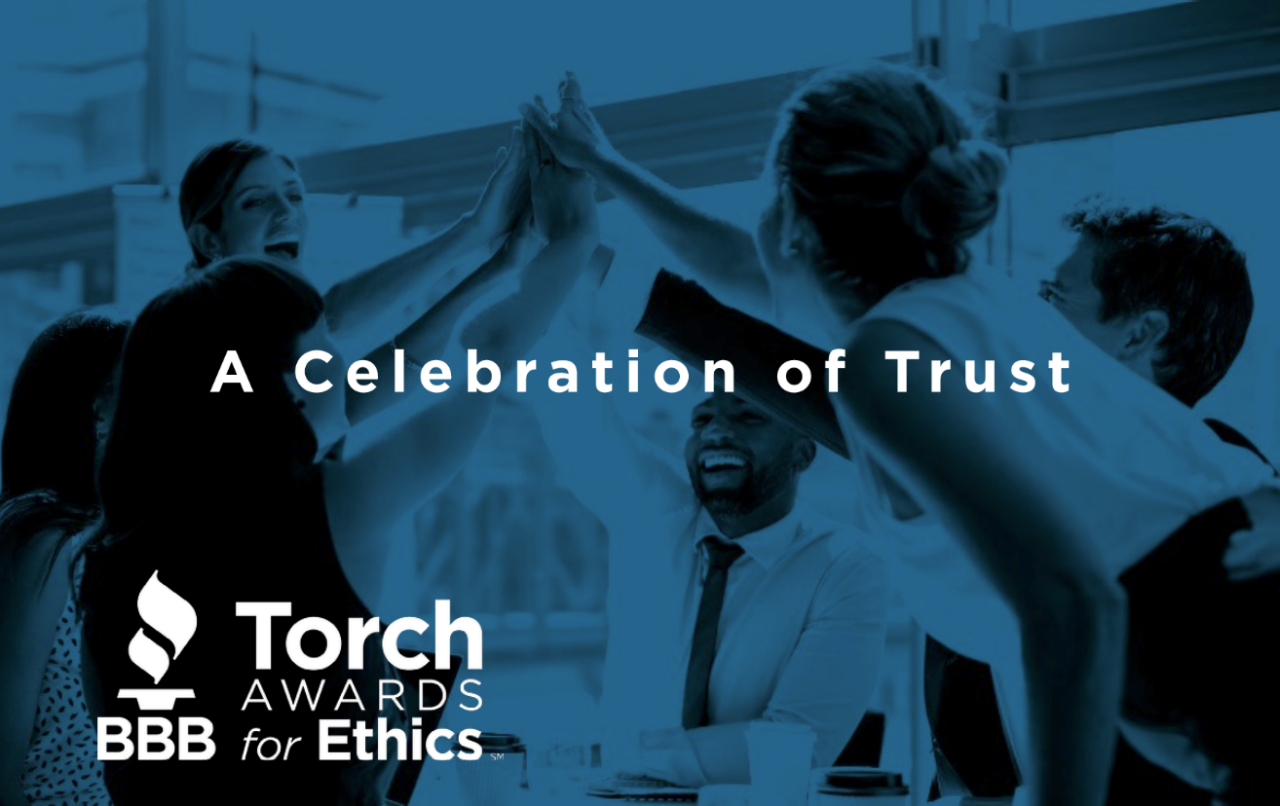 Torch Awards for Ethics Logo white on blue background a celebration of trust with faded image of staffers high fiving