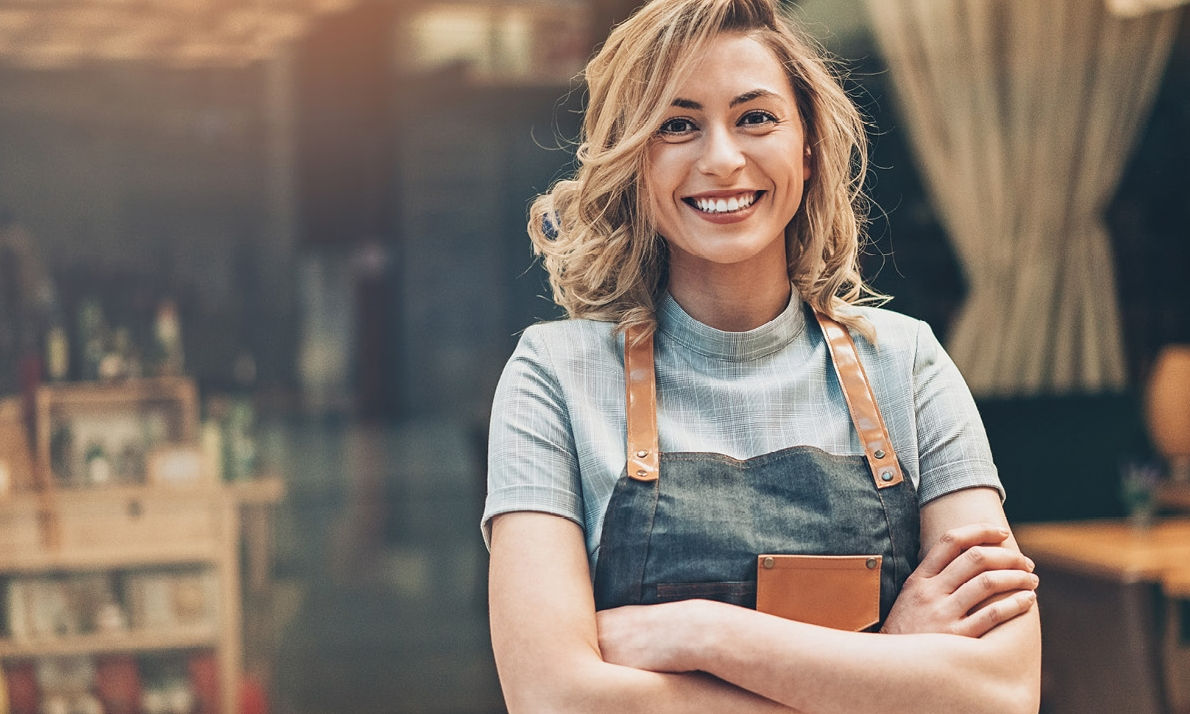 Lady crossing arms wearing an apron