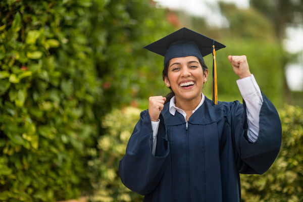 Happy young Hispanic woman graduating.