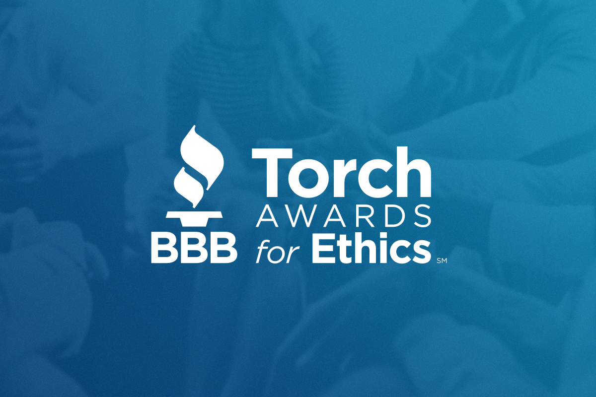 The Torch Awards for Ethics logo over a blue background.