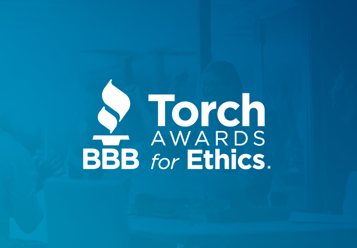 Torch Awards for Ethics Logo white on blue background