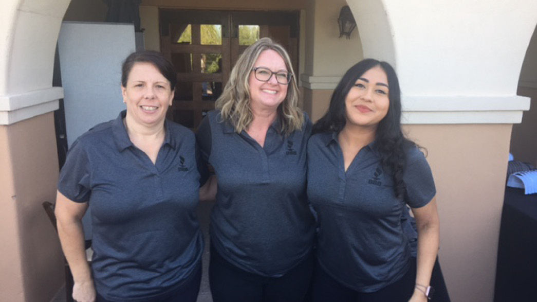 Three female BBBB Pacific Southwest employees smiling at annual BBB Integrity Golf Classic Event